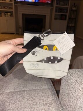 thirty-one White Mummy Face Wristlet with Yellow Eyes